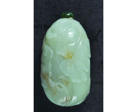  A GOOD CHINESE JADE SNUFF BOTTLE, with stopper, carved in low relief with a butterfly and leafage, 2.8in high.