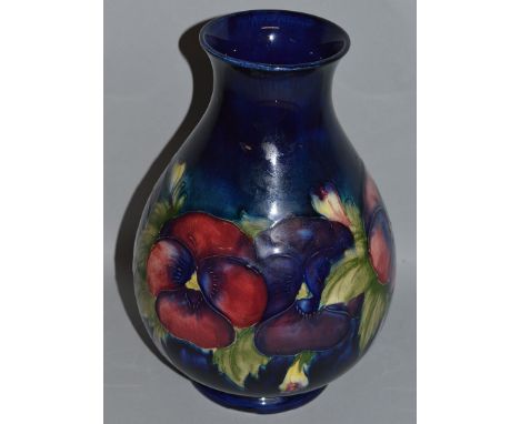 A GOOD MOORCROFT “PANSY” VASE on a blue ground. W. M. mark in green. 10ins high.