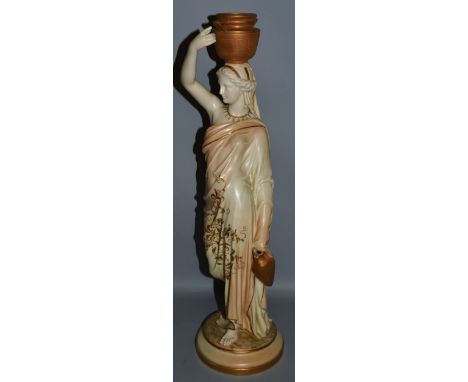 A TALL ROYAL WORCESTER FIGURE OF A CLASSICAL LADY carrying an urn on her head and standing on a circular base. 21ins high.