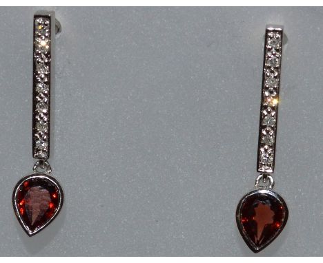 A PAIR OF WHITE DIAMOND AND RUBY EARRINGS.