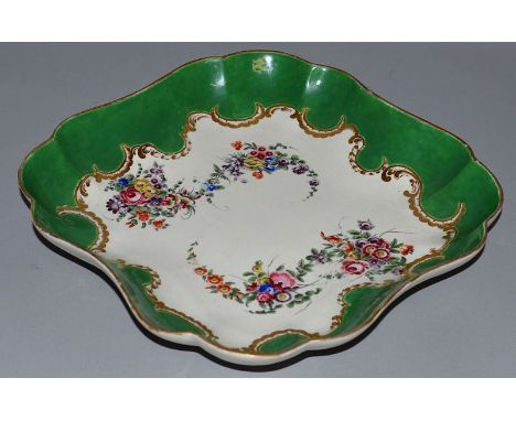 AN 18TH CENTURY WORCESTER SQUARE LOBED DISH painted in the Marchioness of Huntley pattern with flowers under “C” scroll gildi