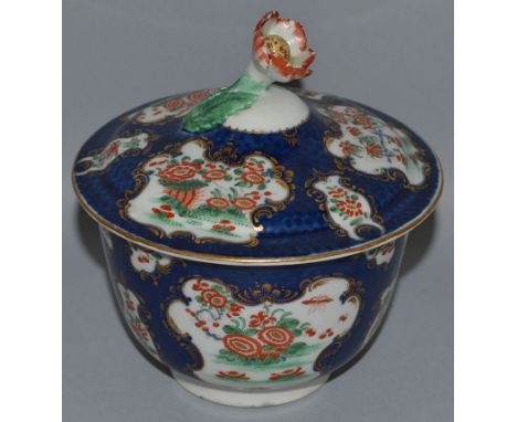 AN 18TH CENTURY WORCESTER SUCRIER AND COVER painted in Kakiemon style with chrysanthemums in gilt mirror shaped panels on a b