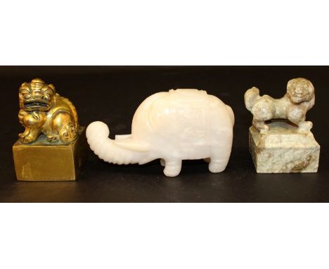 A CHINESE WHITE JADE-LIKE ELEPHANT CARVING, 6in long; together with a gilded soapstone seal, 2.4in square & 3.8in high; and a