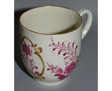 AN 18TH CENTURY WORCESTER COFFEE CUP painted with puce flowers and a gilt panel in Meissen style 284.