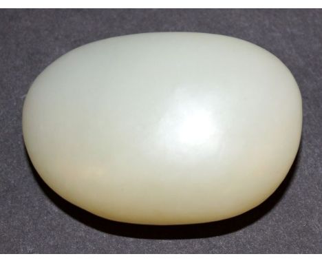A CHINESE CELADON JADE PEBBLE, 2.1in long.