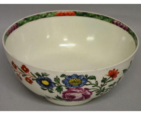 AN 18TH CENTURY WORCESTER BOWL painted with a large cabbage and other colourful flowers in the manner of James Rogers, the in