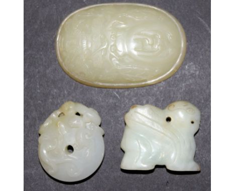 A CHINESE WHITE JADE BI DISC, carved in high relief with a group of sinuous chilong, 1.9in wide; together with two other jade