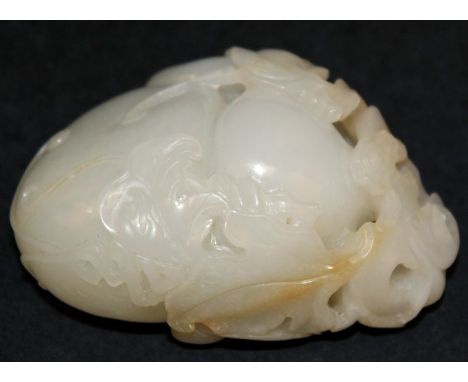 A GOOD QUALITY CHINESE JADE GOURD, carved to one end with enveloping leafage, 2.75in long.
