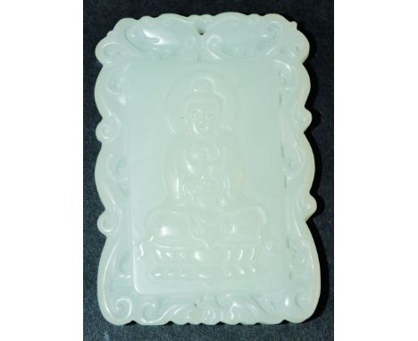  A CHINESE WHITE JADE PENDANT, the front carved in upraised relief with Buddha seated on a lotus throne, within a double drag