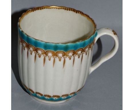 AN 18TH CENTURY WORCESTER FLUTED COFFEE CUP painted with turquoise upper and lower borders with stylised gilding and dentil g
