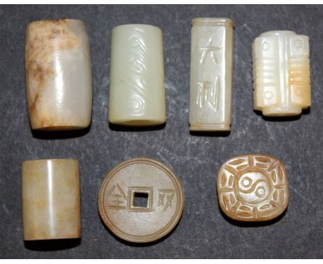 A GROUP OF SEVEN CHINESE JADE-LIKE BEADS, of archaic design, the longest 1.3in long. (7)