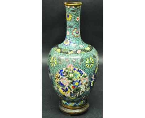 A CHINESE CLOISONNE VASE, circa 1900, together with a fitted wood stand, the vase decorated with circular panels of flowerhea