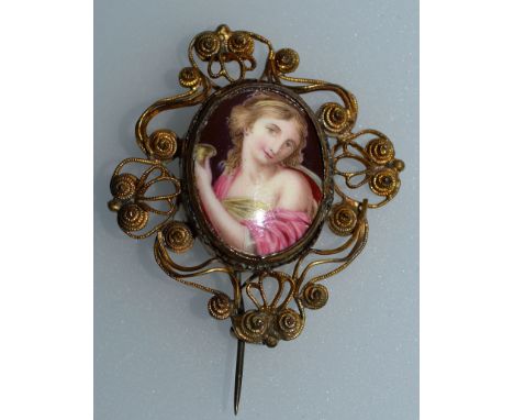 A VICTORIAN OVAL BROOCH set with a porcelain portrait of a young girl.