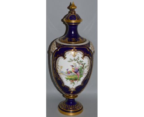 A GOOD ROYAL WORCESTER FINE VASE AND COVER painted with exotic birds on a cobalt blue ground in the manner of George Johnson 