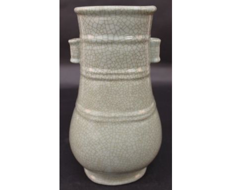 A CHINESE CRACKLEGLAZE CELADON ARROW VASE, of Hu form, the neck with moulded ribbing, the base with a Qianlong seal mark, 11.