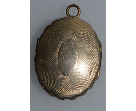 A 9CT YELLOW GOLD ENGINE TURNED OVAL LOCKET.
