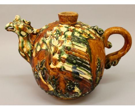  A LARGE CHINESE SANCAI PHOENIX-HEAD CERAMIC EWER, the body moulded in green, amber and white, the base bearing a Tang Dynast