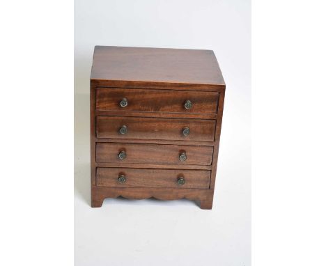 Antique mahogany four drawer apprentice chest with knob handles and bracket feet, 24cm wide