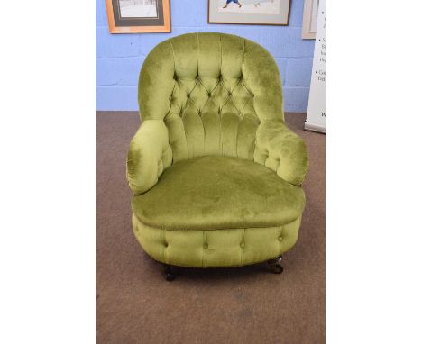 Victorian green upholstered button back armchair on short turned legs with casters, 78cm high