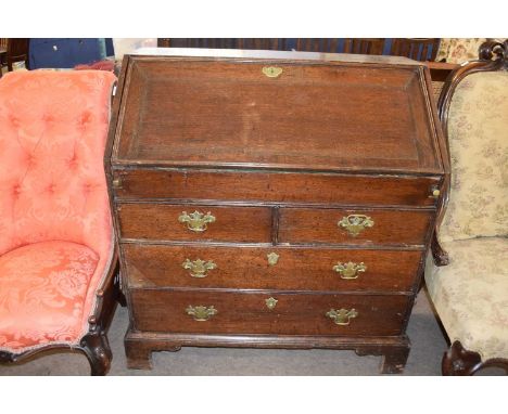 18th century oak bureau, the fall front opening to an interior fitted with small drawers, pigeonholes and a central cupboard 