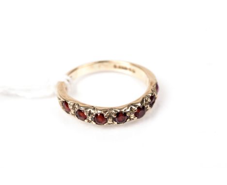 A vintage 9ct gold and round mixed-cut garnet seven stone ring. Hallmarks for London 1960, size M, 2.4g gross