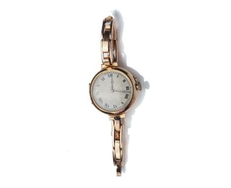 An early 20th century lady's 15ct gold cased bracelet watch, circa 1919. The silvered star-burst engine-turned dial with blac