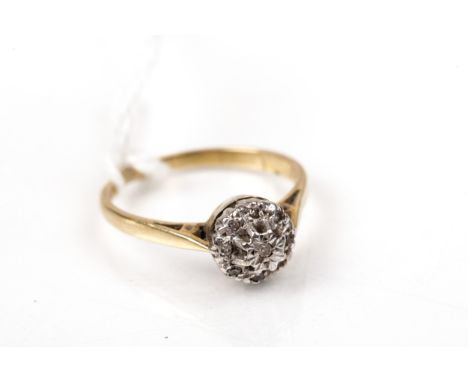 A vintage 18ct gold and diamond nine stone cluster ring. The small eight-cut stones all illusion set in white on yellow gold 