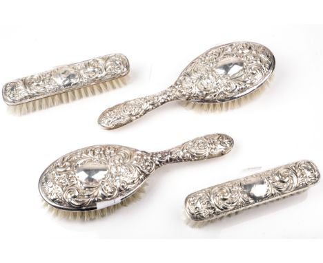 Two pairs of vintage silver mounted brushes. Comprising two oval hair brushes and two clothes brushes, each embossed with a b