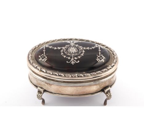 An early 20th century silver and tortoiseshell pique oval trinket box. The hinged lid with an embossed hare-bell border and i