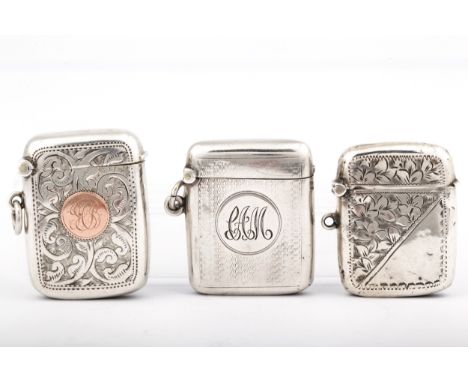 Three Victorian and later silver vesta or match cases. Comprising; an example with engine turning around a round reserve with