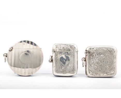 Three early 20th century silver vesta or match cases. Comprising; a round engine turned example, mark of Joseph Gloster Ltd, 