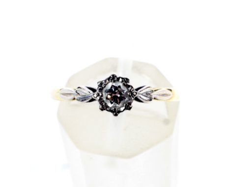 A vintage gold and diamond solitaire ring. The round brilliant approx. 0.18cts, illusion set in white between leaf-shaped sho