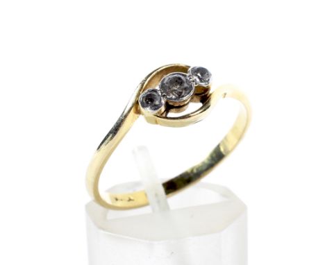 A vintage paste three-stone cross-over ring. The graduated near colourless pastes rub-over set in white between open yellow c