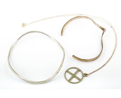 Two modern silver bangles and a pendant. Comprising a 'wavy' slave bangle, London 2001 and a cross-over torque bangle, post 2