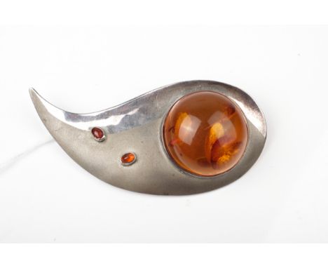 A vintage 1970s designer amber brooch in the form of a part polished and satinised stylised swoosh. Set with a large round ca