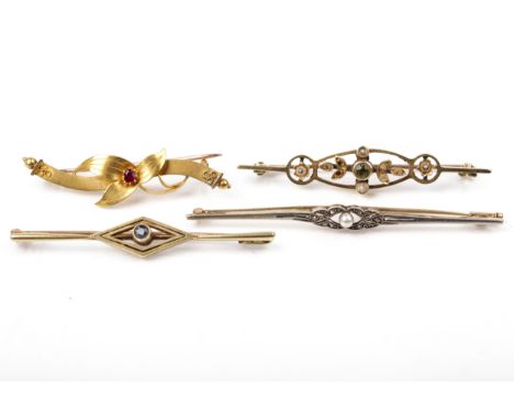 Four early 20th century gold and gem set brooches. Comprising; a scroll and leaf-trefoil brooch centred with a small ruby, st