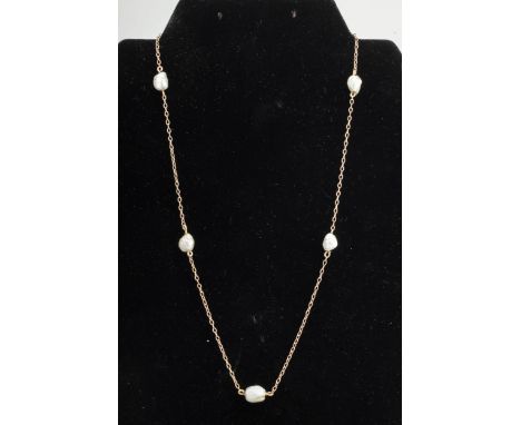 An early 20th century gold and baroque pearl necklace. The oval trace chain strung at intervals with five baroque pearls (unw