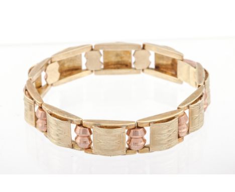 A vintage Continental bi-colour gold bracelet. In the form of ten part-satinised domed-rectangular yellow links spaced by spo