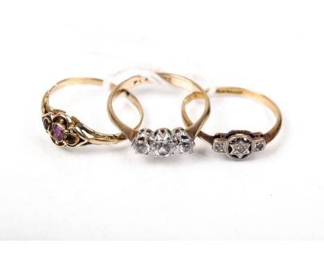 Three Victorian and later gold and gem set rings. Comprising; a late Victorian ruby ring set with two (of three) small rubies