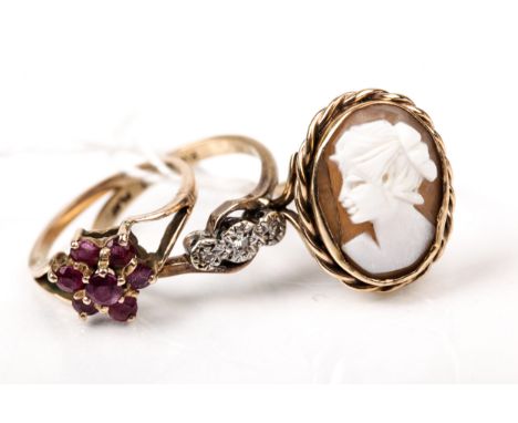 Three vintage gold and gem set rings. Comprising; a small diamond three stone cross-over ring, stamped '9ct Plat', size L; a 