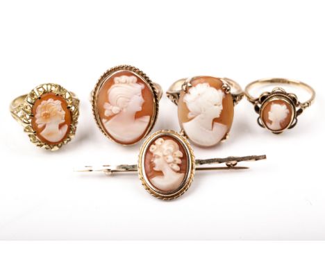 Four vintage gold and oval shell cameo rings and a similar bar brooch. All depicting an unknown female bust, the rings each w