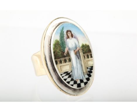A Continental polychrome enamelled oval panel ring depicting an angel. Holding a palm branch and a dagger emblematic of victo