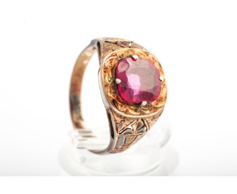 An early 20th century gold and synthetic-ruby single stone ring. The cushion-shaped Verneuil synthetic-ruby claw set within a