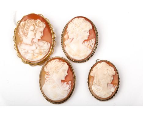 Four vintage gold and oval shell cameo brooches depicting unknown female busts. Three with rope-twist borders, one of which i