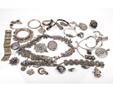A collection of mostly Indian, ethnic and foreign white metal jewellery. Including an Indian Makara head bangle; an oval lock