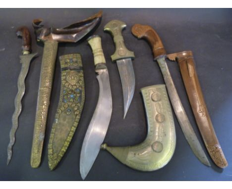 A Kukri with Bone Grip and Decorative Scabbard, a jambiya and two kris complete with scabbards