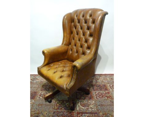 A Reproduction Tan Leather Button Upholstered Wingback Swivel Office Armchair