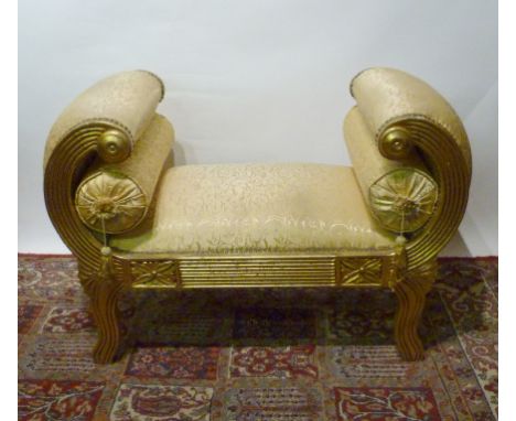 A Regency Style Gilded Stool of Double Scroll Form with Reeded Scroll Legs, 116 cms wide