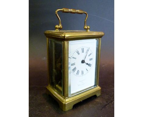 A Late 19th Century Brass Cased Carriage Clock, the enamel dial inscribed 'Made in Paris for James Shoolbred & Co.'