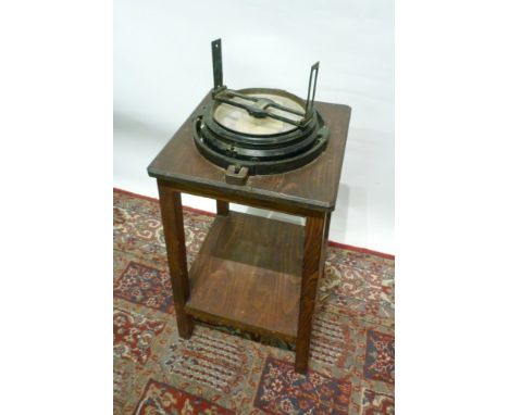 A Continental Ebonised Ships Compass with Gimble, mounted upon a two tier table